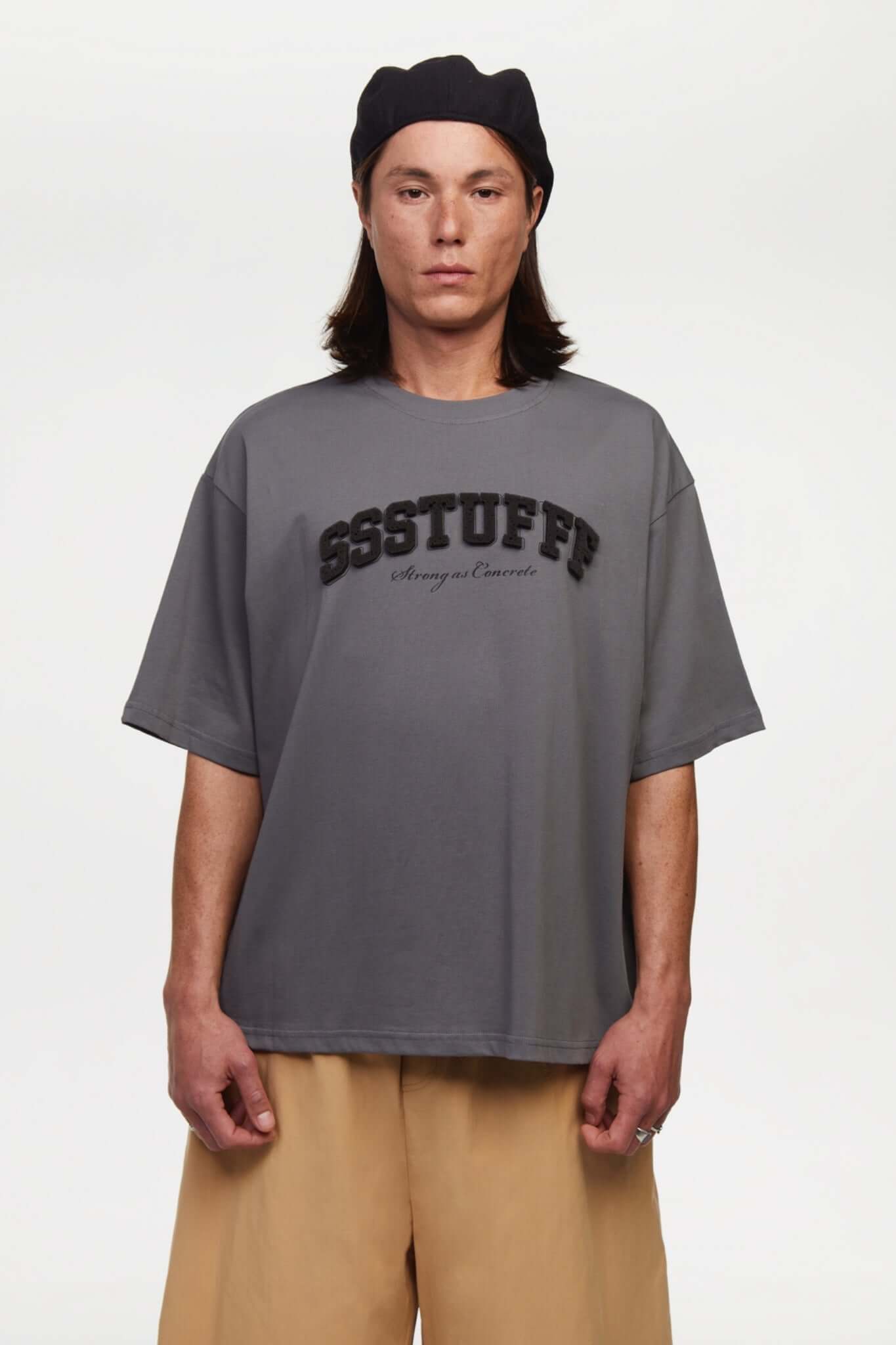 Gray t-shirt with sponge texture text with the brand name
