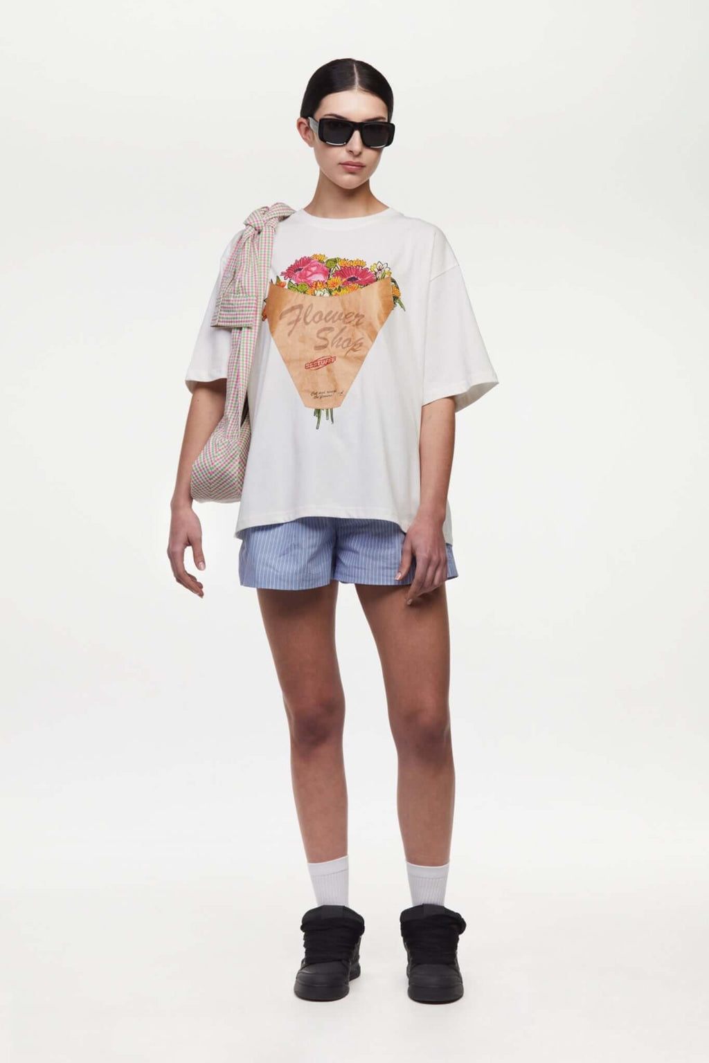 White t-shirt with a graphic of a flower shop cone that you can break 
