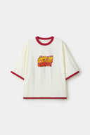 White t-shirt with red trim and fire yellow and red graphic
