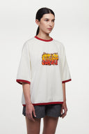 White t-shirt with red trim and fire yellow and red graphic
