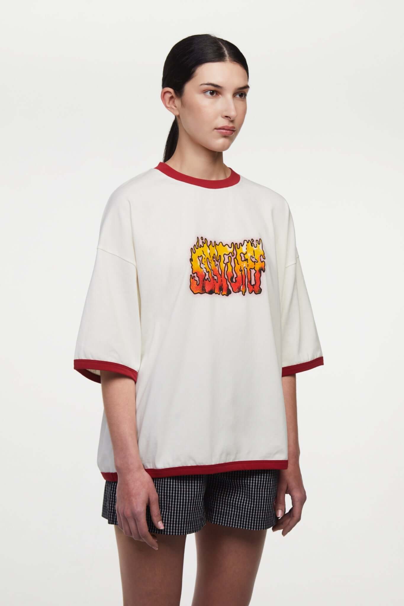 White t-shirt with red trim and fire yellow and red graphic
