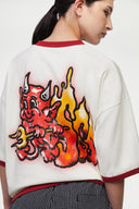 White t-shirt with red trim and fire yellow and red graphic
