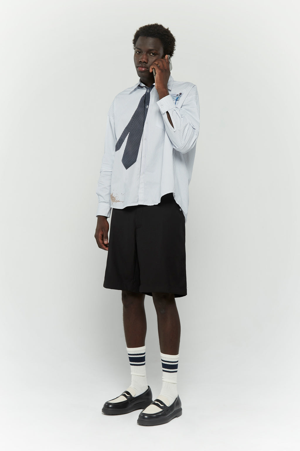 Light blue stripes shirt with a black tie graphic 
