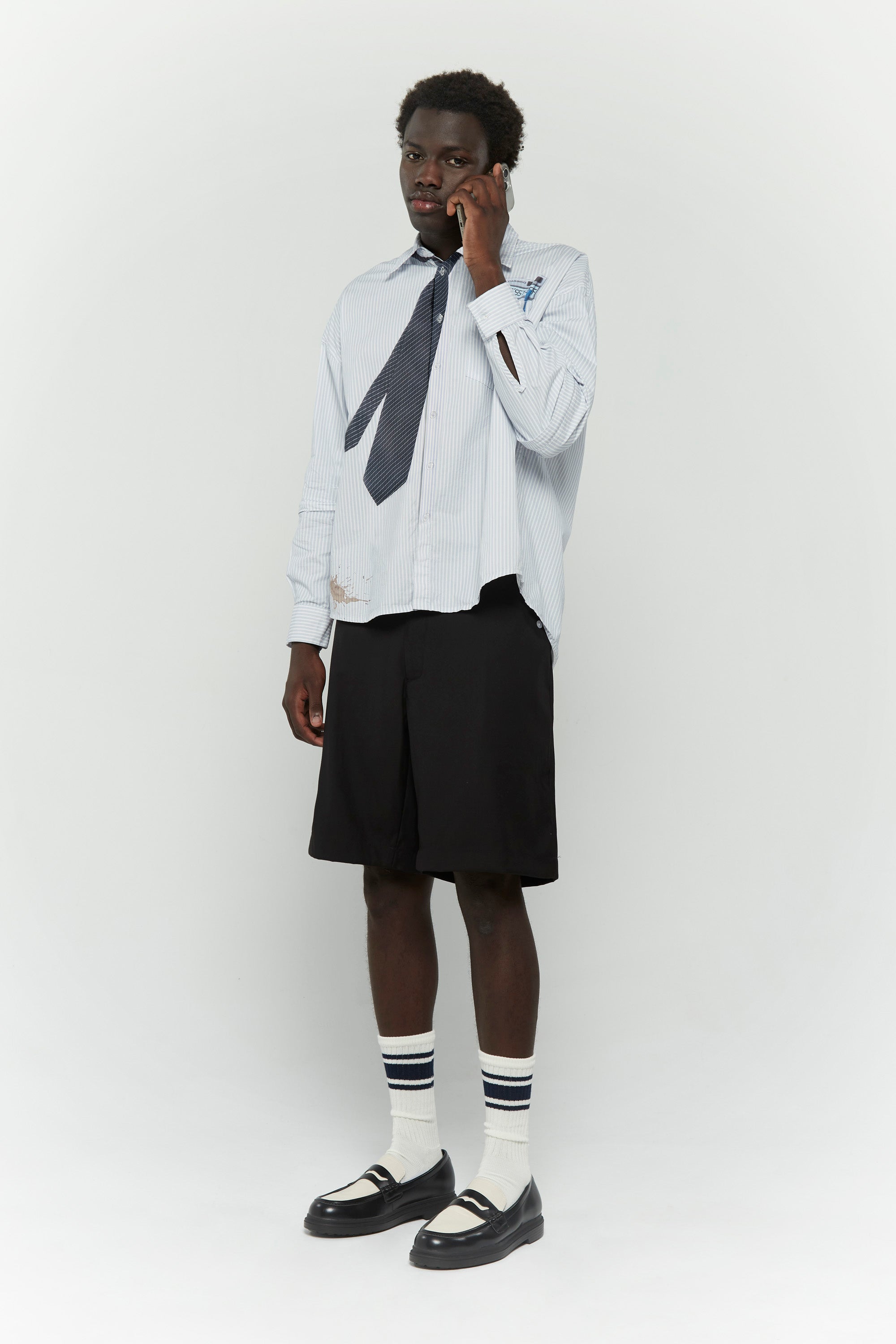 Light blue stripes shirt with a black tie graphic 
