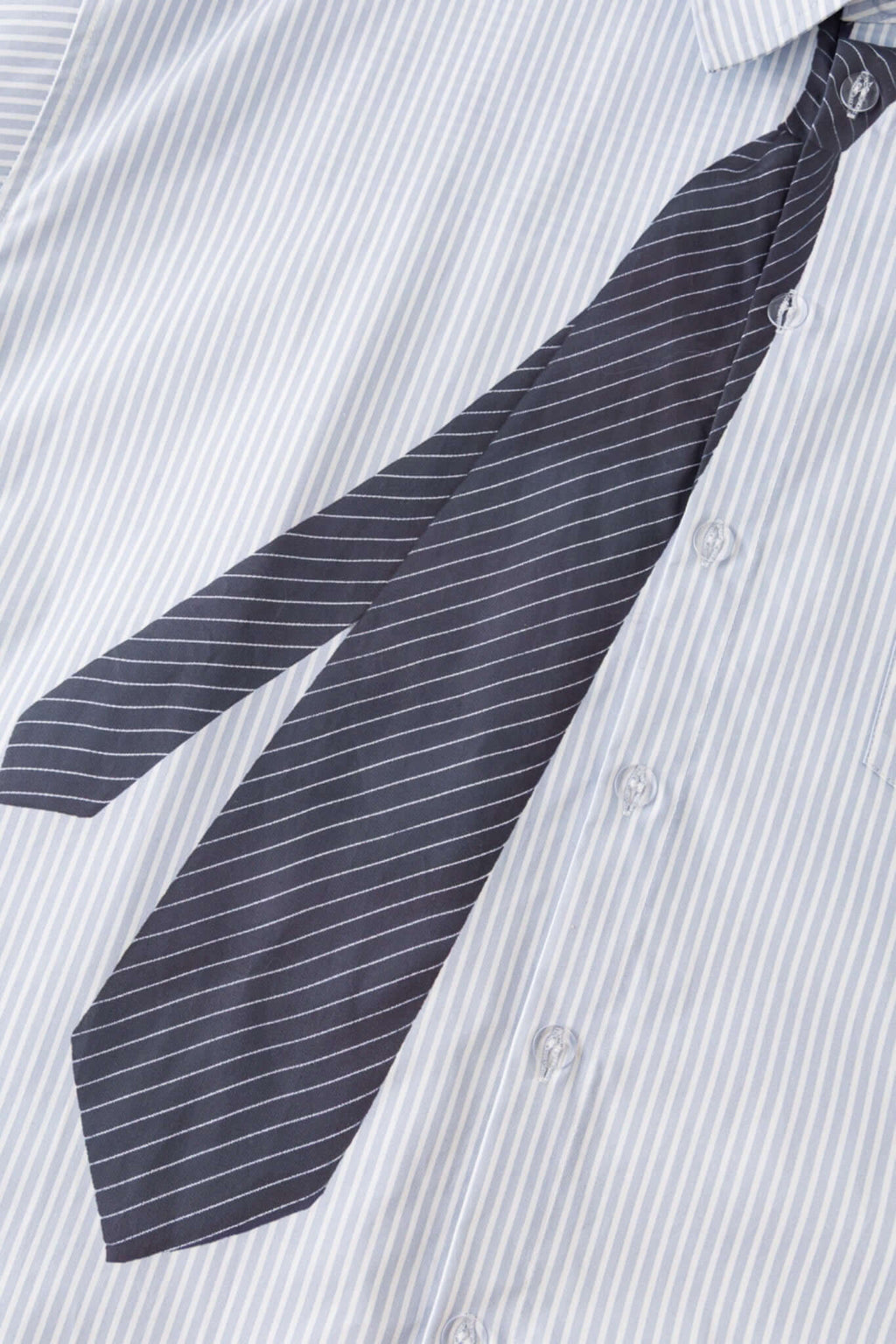 Light blue stripes shirt with a black tie graphic 
