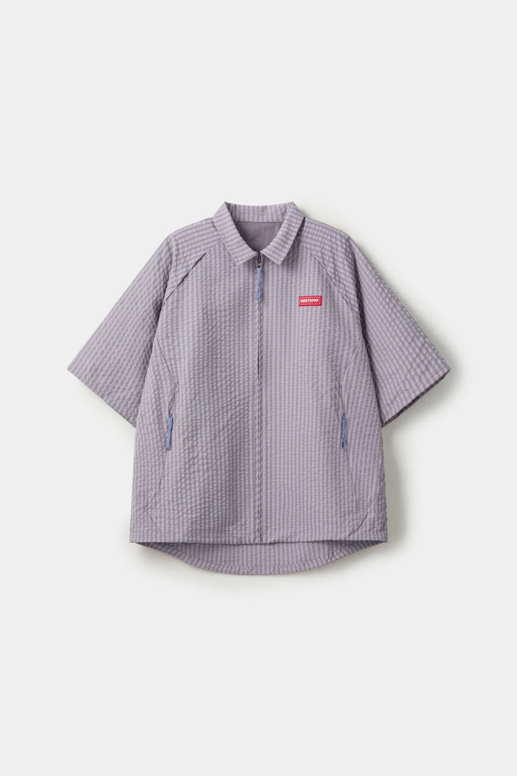 Grey checkered shirt with a red logo and red details in the zipper
