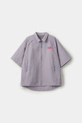 Grey checkered shirt with a red logo and red details in the zipper
