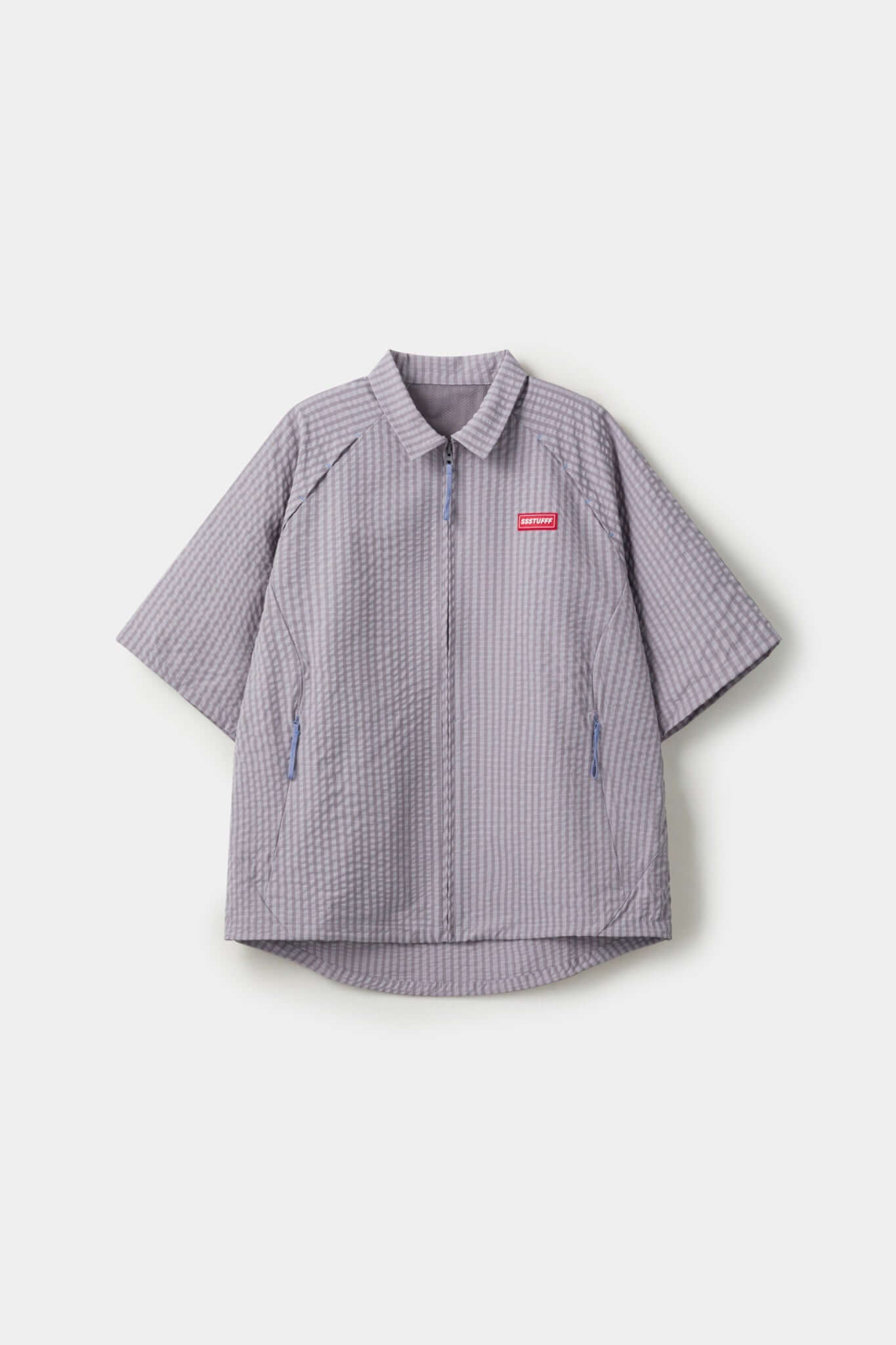 Grey checkered shirt with a red logo and red details in the zipper
