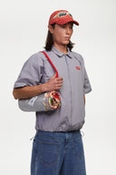 Grey checkered shirt with a red logo and red details in the zipper
