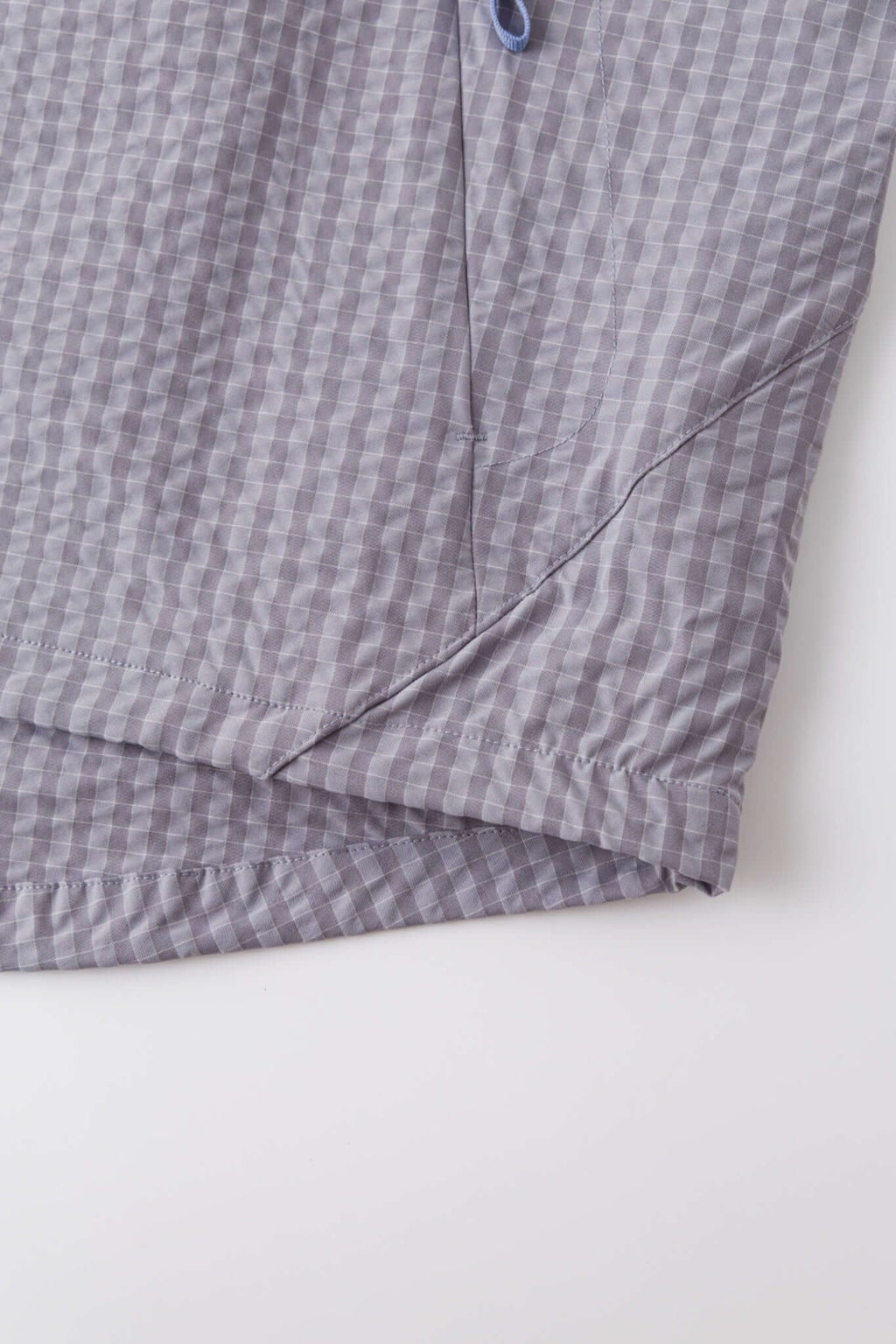 Grey checkered shirt with a red logo and red details in the zipper
