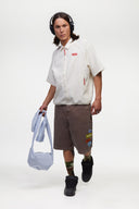 Brown denim shorts with vinyl patches 