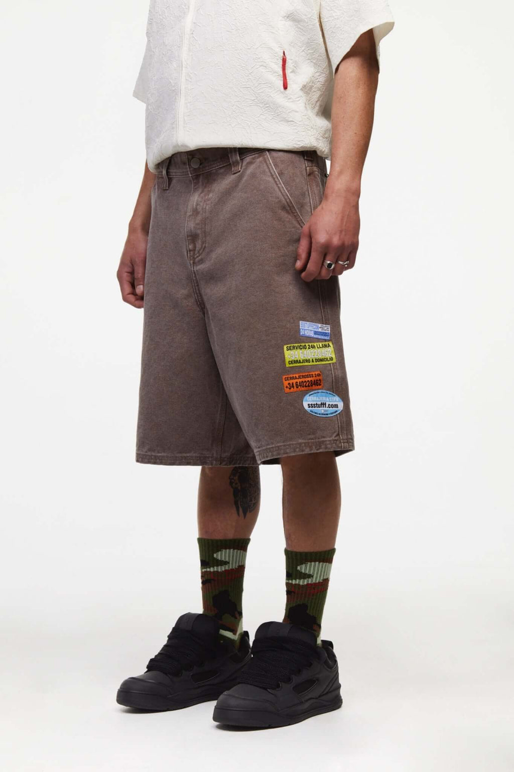 Brown denim shorts with vinyl patches
