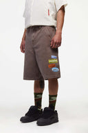Brown denim shorts with vinyl patches