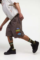 Brown denim shorts with vinyl patches
