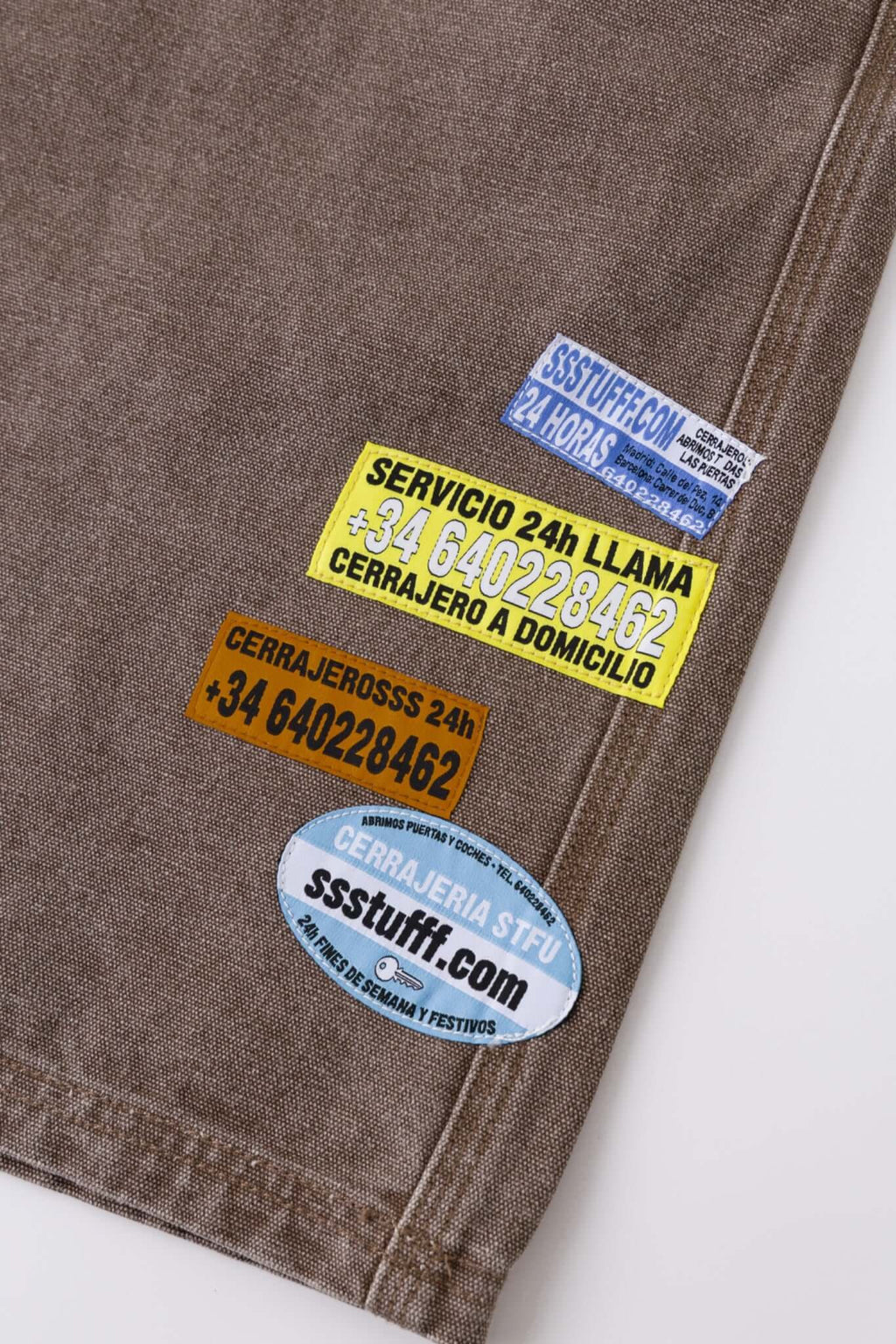 Brown denim shorts with vinyl patches
