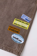Brown denim shorts with vinyl patches
