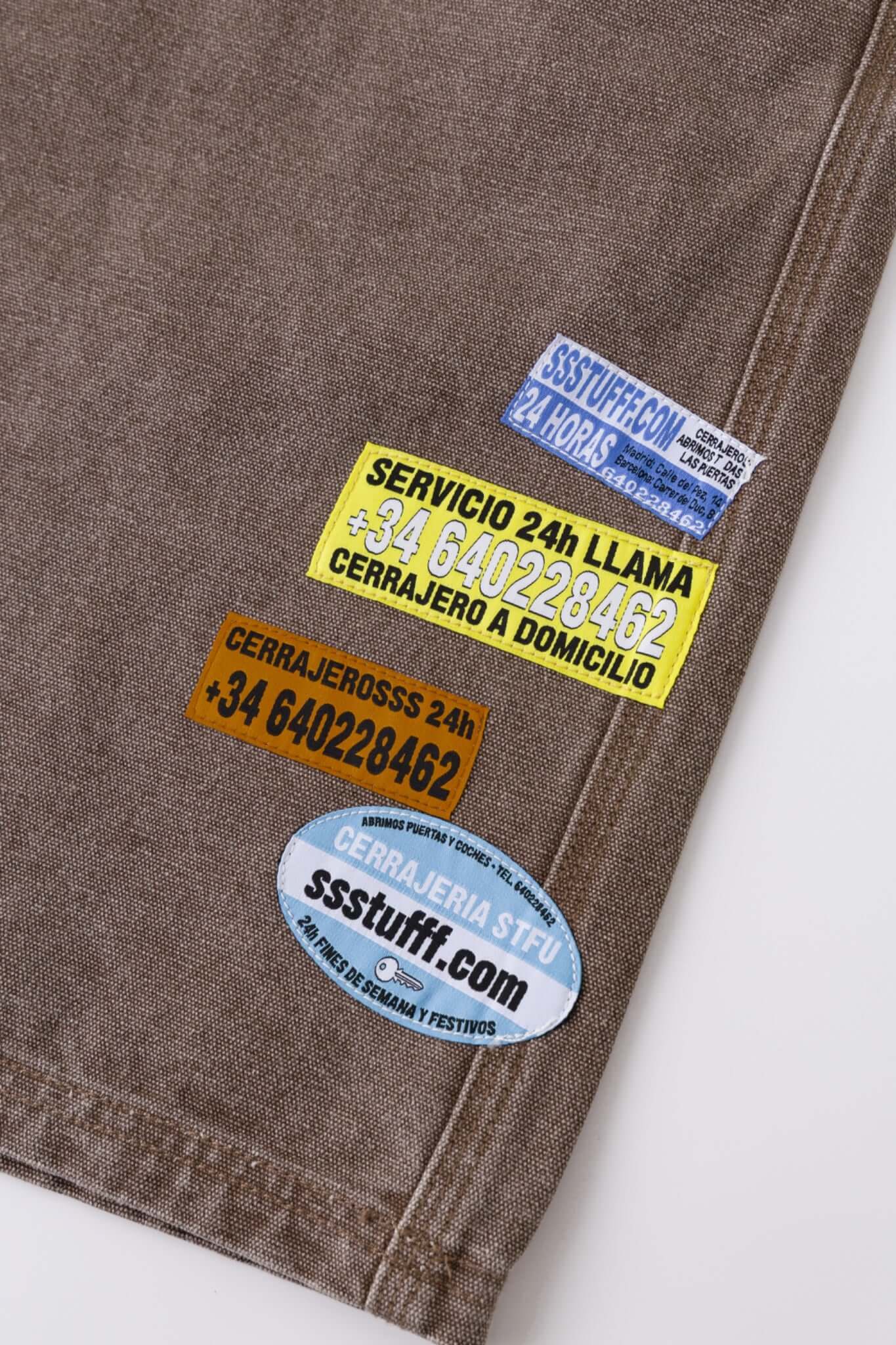Brown denim shorts with vinyl patches

