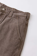 Brown denim shorts with vinyl patches
