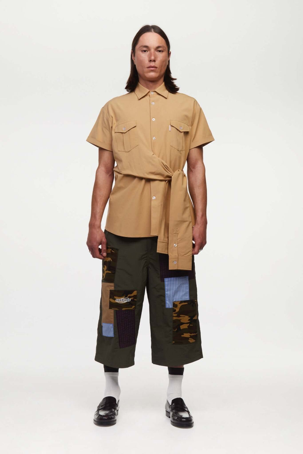 Green patchwork pants with various patterns 
