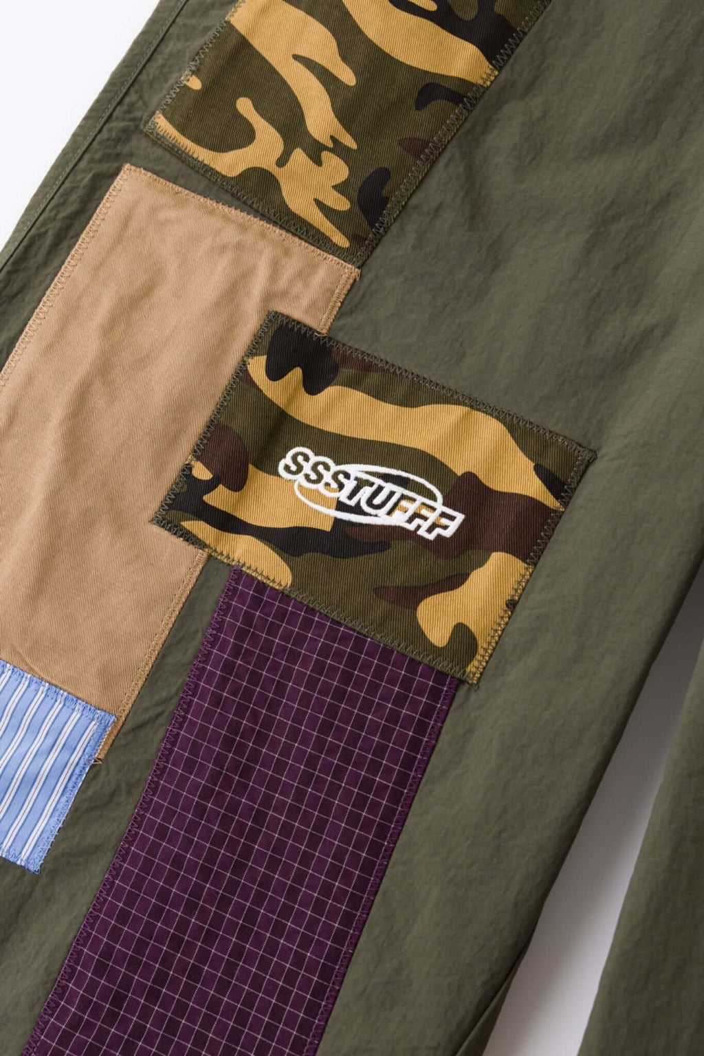 Green patchwork pants with various patterns 
