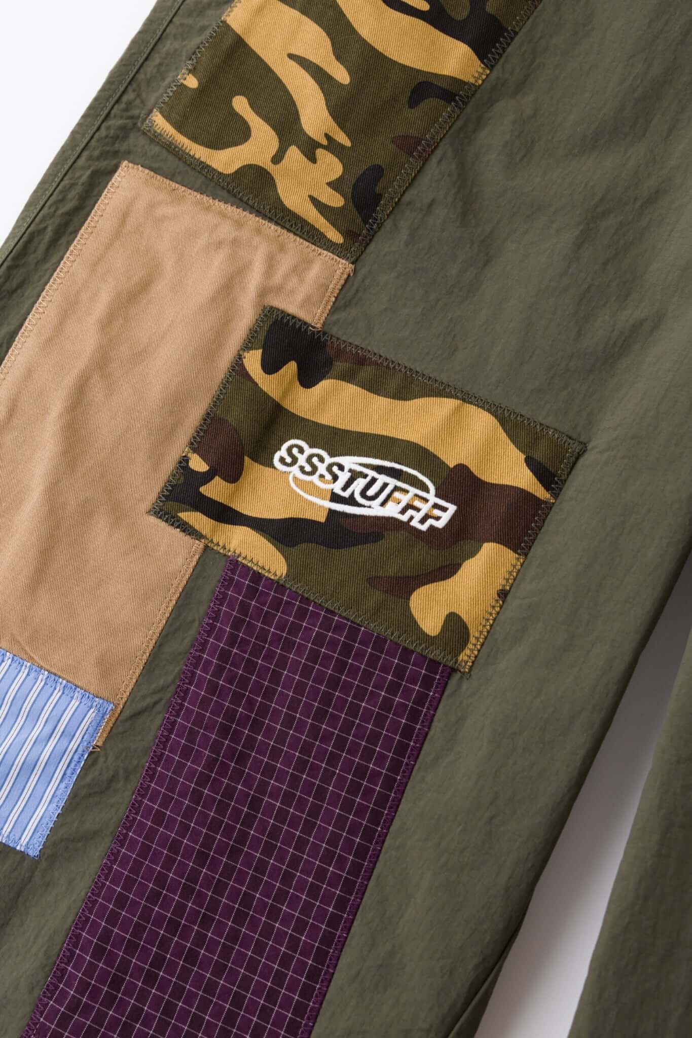 Green patchwork pants with various patterns 
