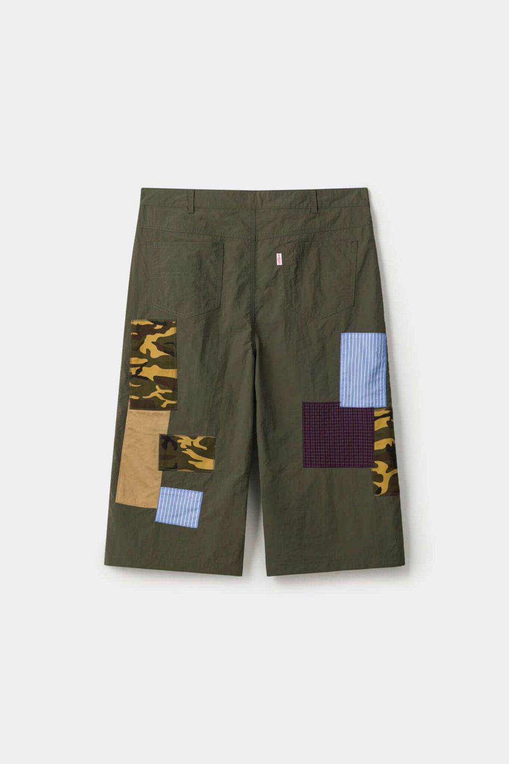 Green patchwork pants with various patterns 
