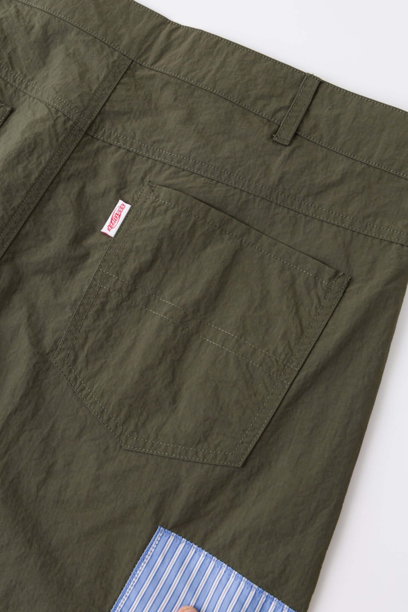 Green patchwork pants with various patterns 
