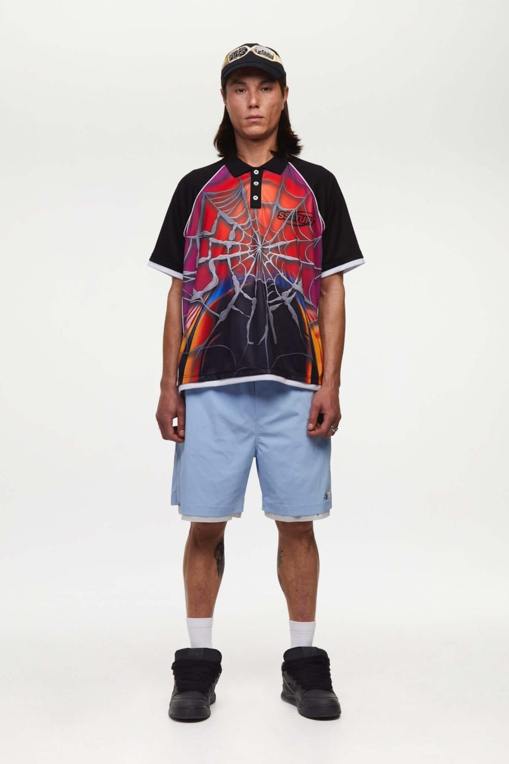 Black jersey shirt with a colorful spider web design with the word SSSTUFFF on it
