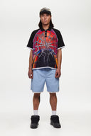 Black jersey shirt with a colorful spider web design with the word SSSTUFFF on it
