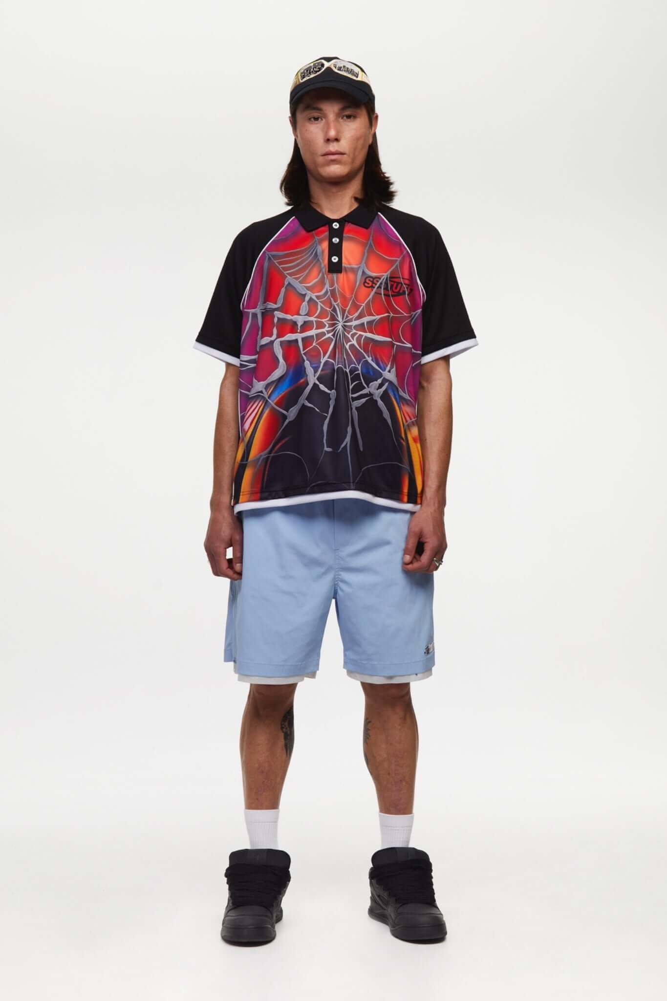 Black jersey shirt with a colorful spider web design with the word SSSTUFFF on it
