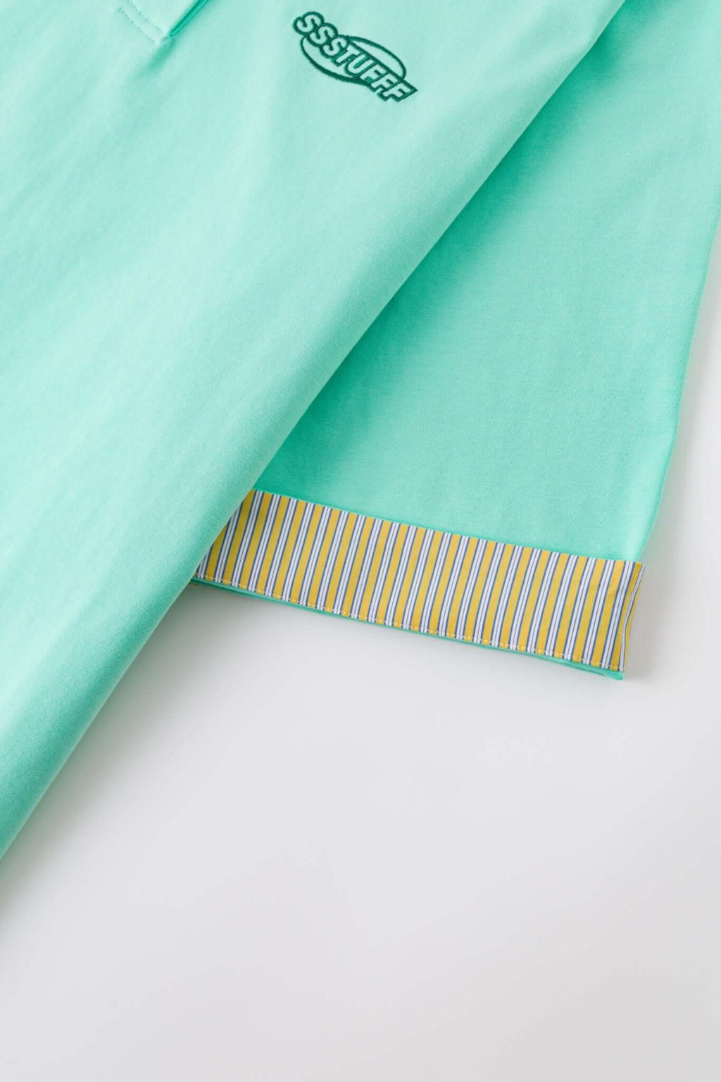 Turquoise polo shirt with checkered collar and sleeves