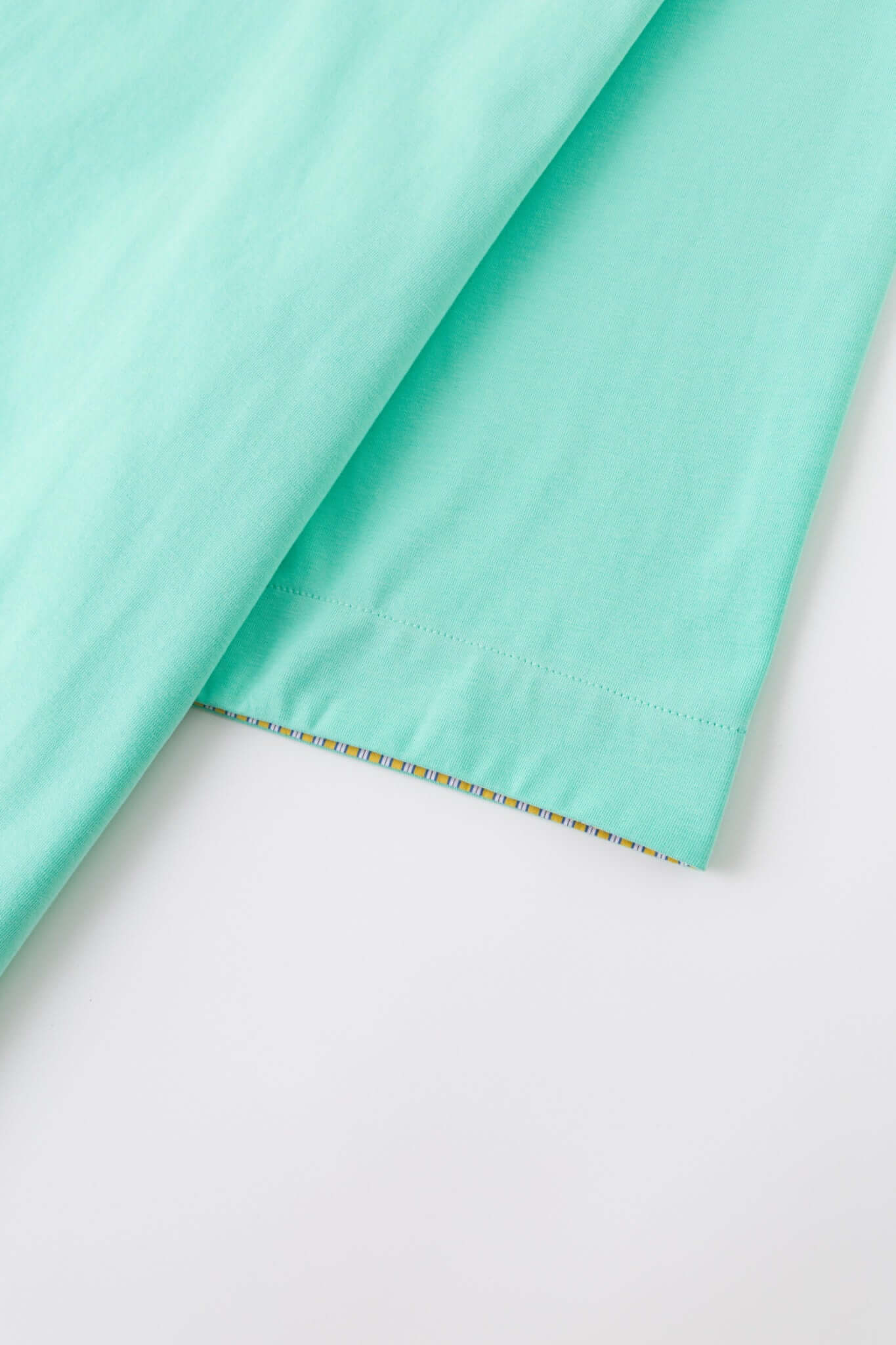 Turquoise polo shirt with checkered collar and sleeves
