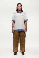 White polo shirt with checkered collar and sleeves
