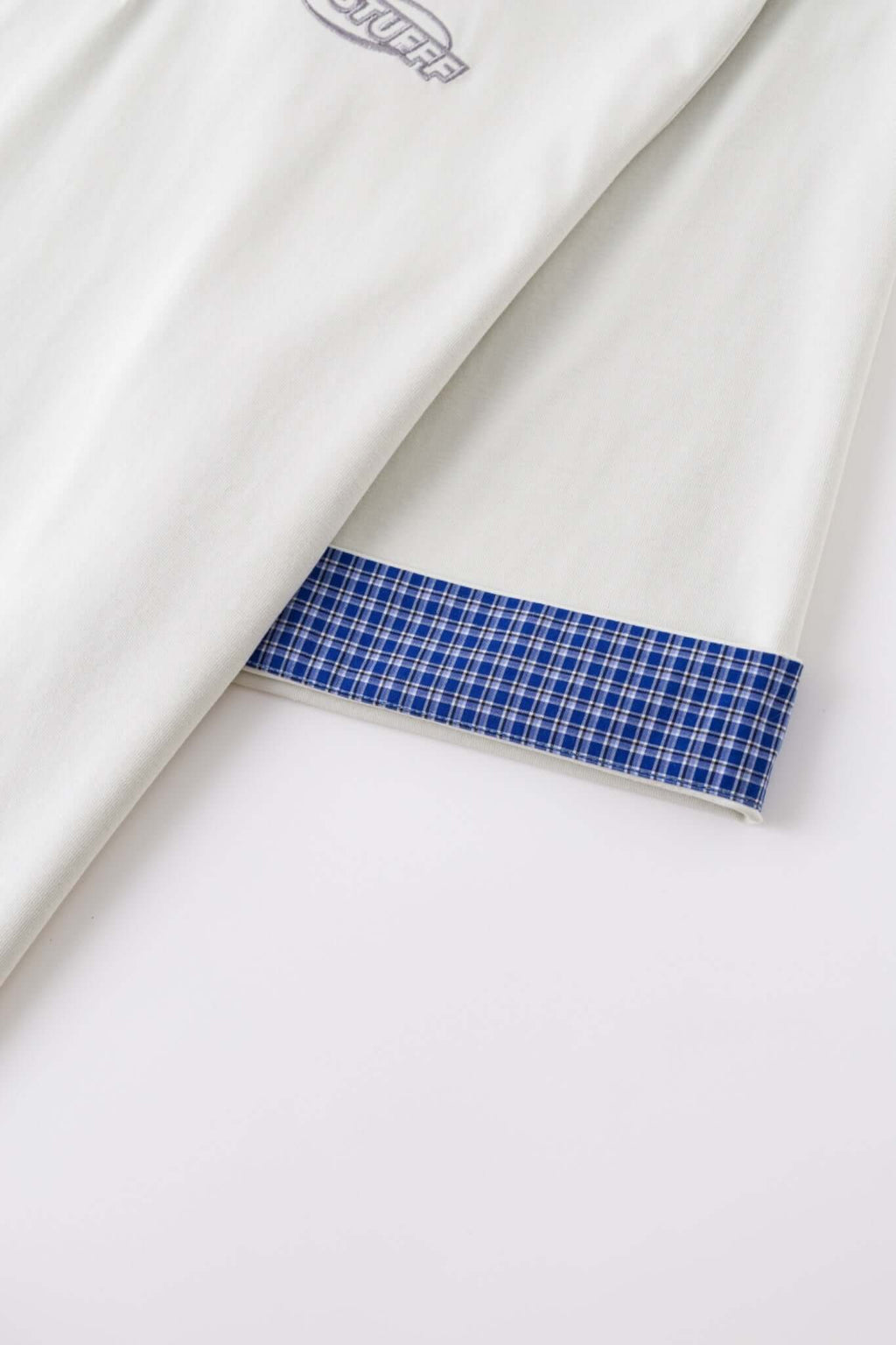 White polo shirt with checkered collar and sleeves
