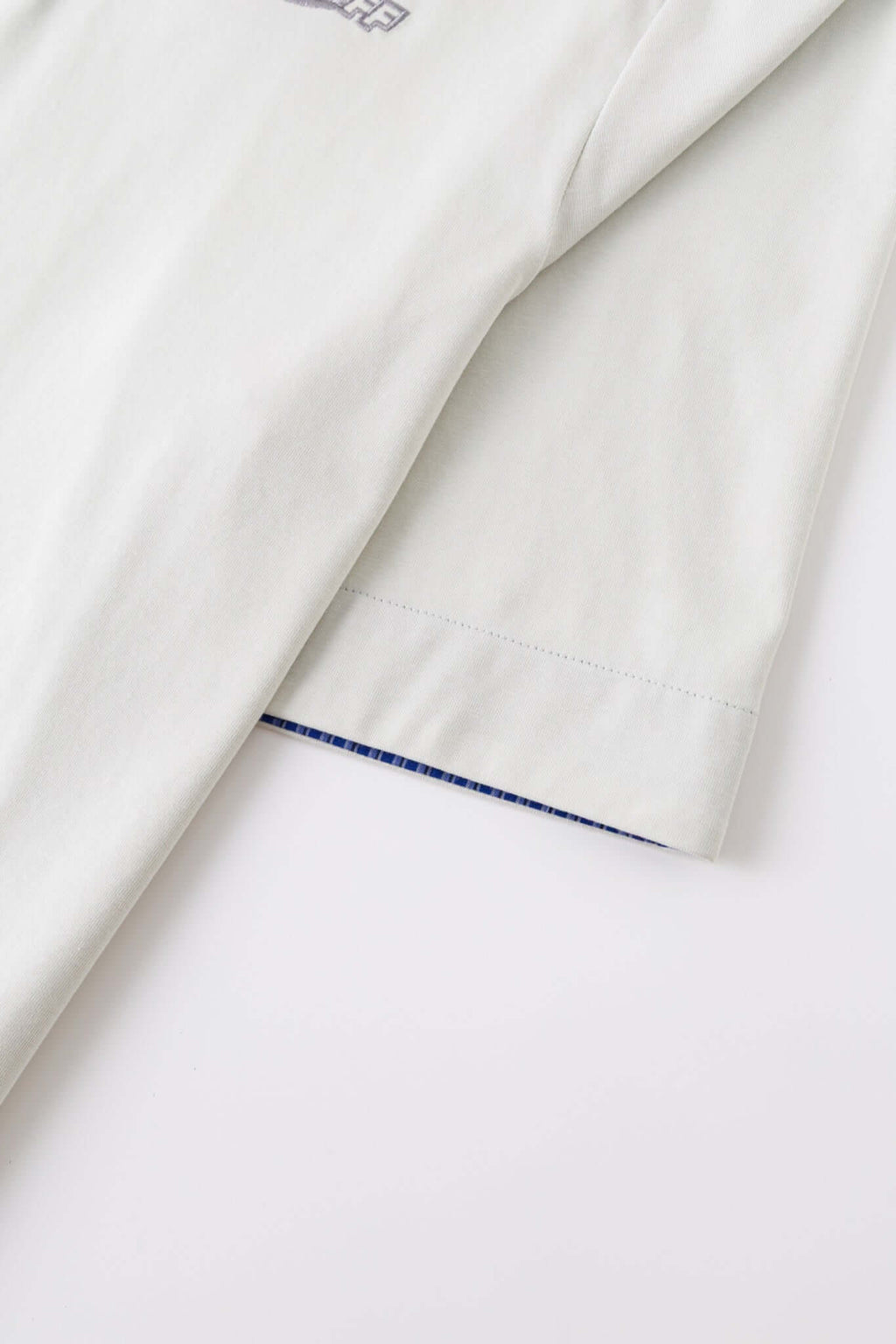 White polo shirt with checkered collar and sleeves
