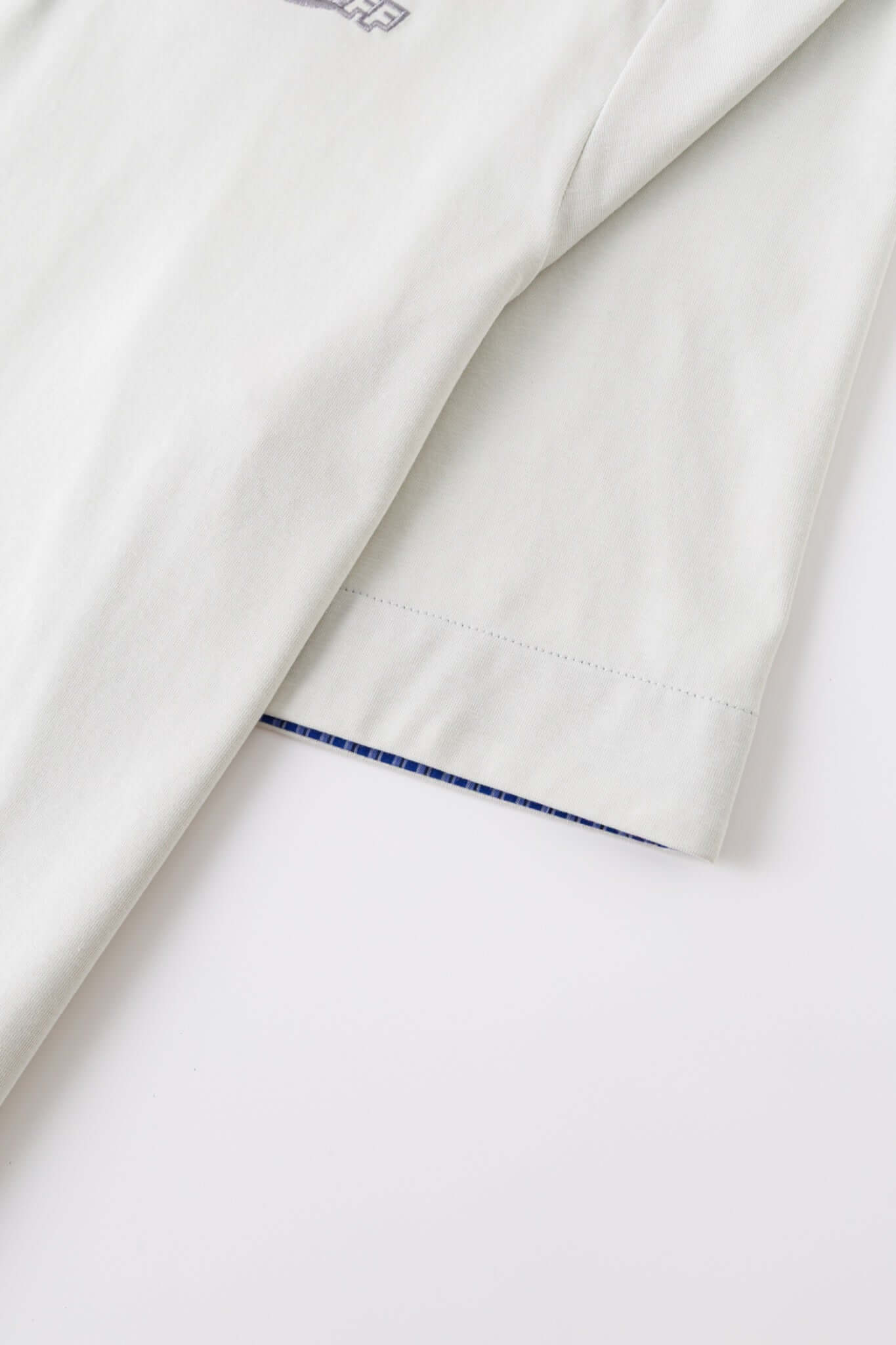 White polo shirt with checkered collar and sleeves
