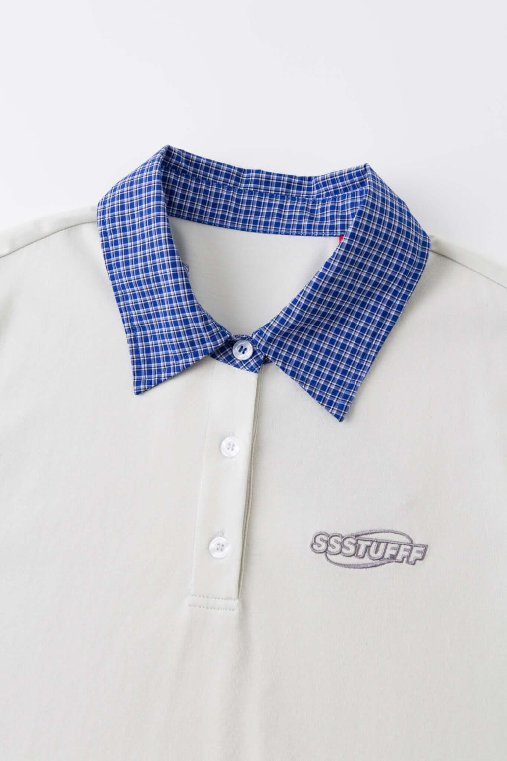White polo shirt with checkered collar and sleeves
