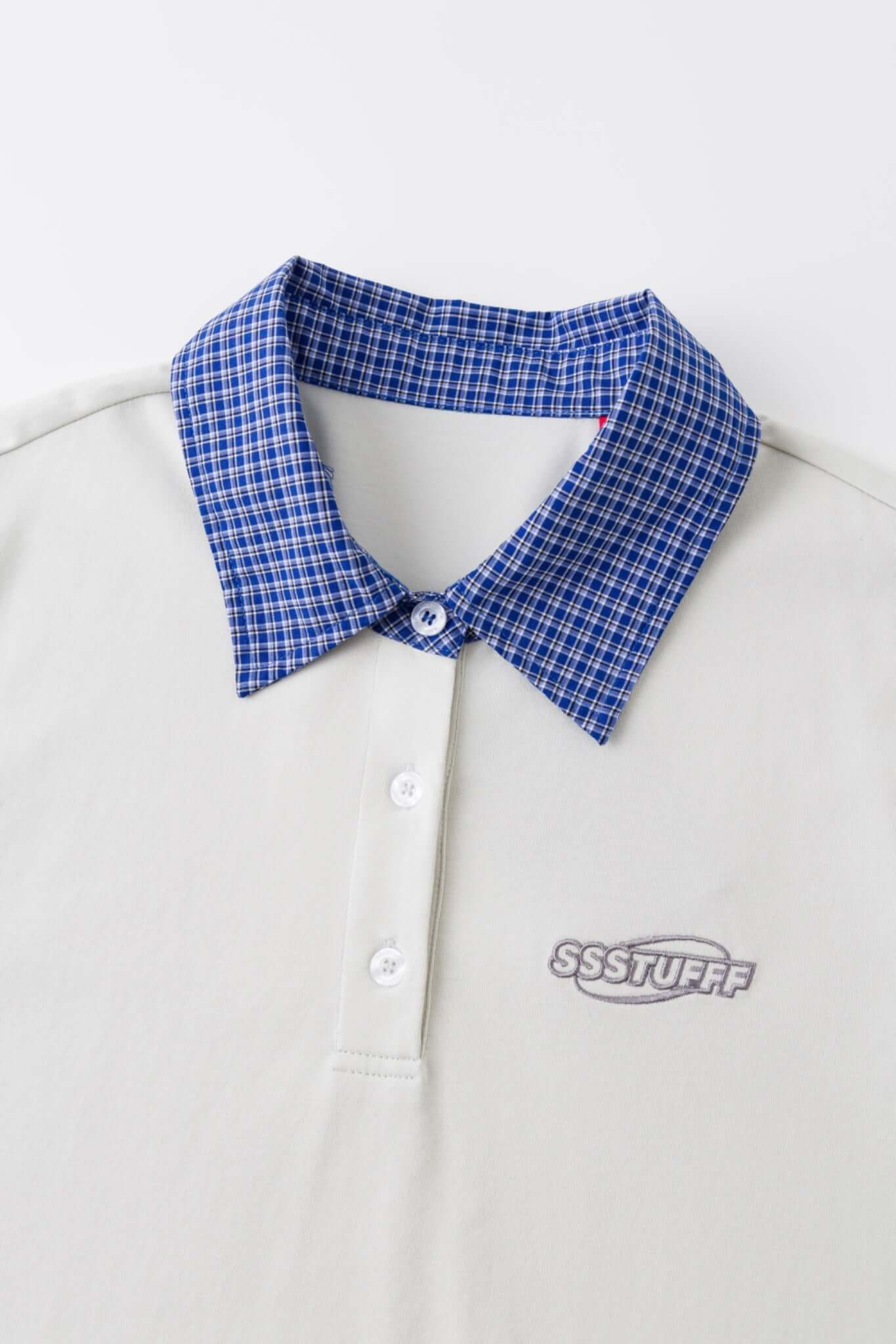 White polo shirt with checkered collar and sleeves
