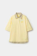 Yellow polo shirt with checkered collar and sleeves
