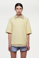 Yellow polo shirt with checkered collar and sleeves
