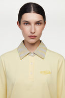 Yellow polo shirt with checkered collar and sleeves
