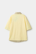 Yellow polo shirt with checkered collar and sleeves
