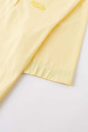 Yellow polo shirt with checkered collar and sleeves
