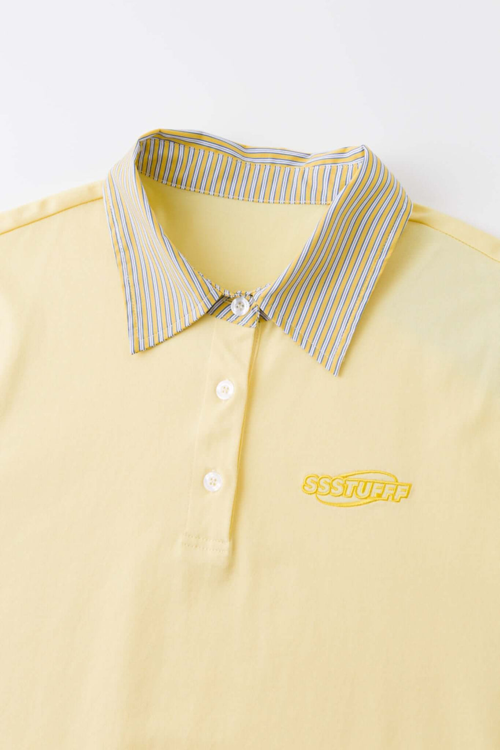 Yellow polo shirt with checkered collar and sleeves
