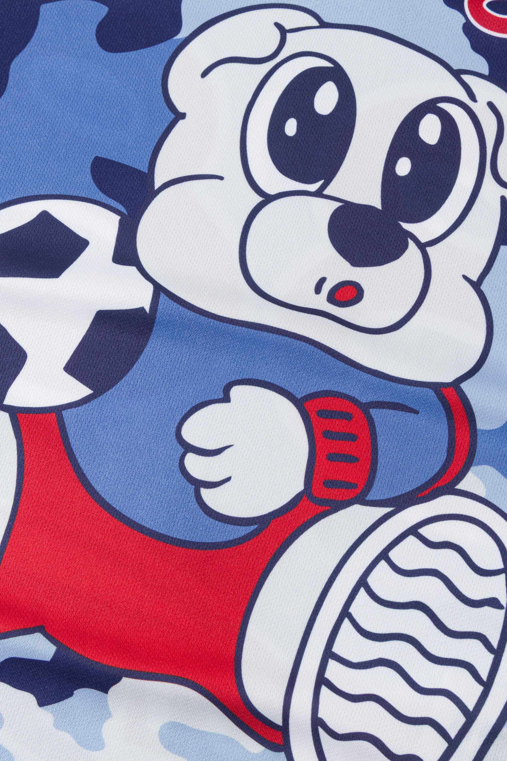 Close-up of a cartoon character in a red and blue outfit with a soccer ball graphic on a blue camouflage jersey