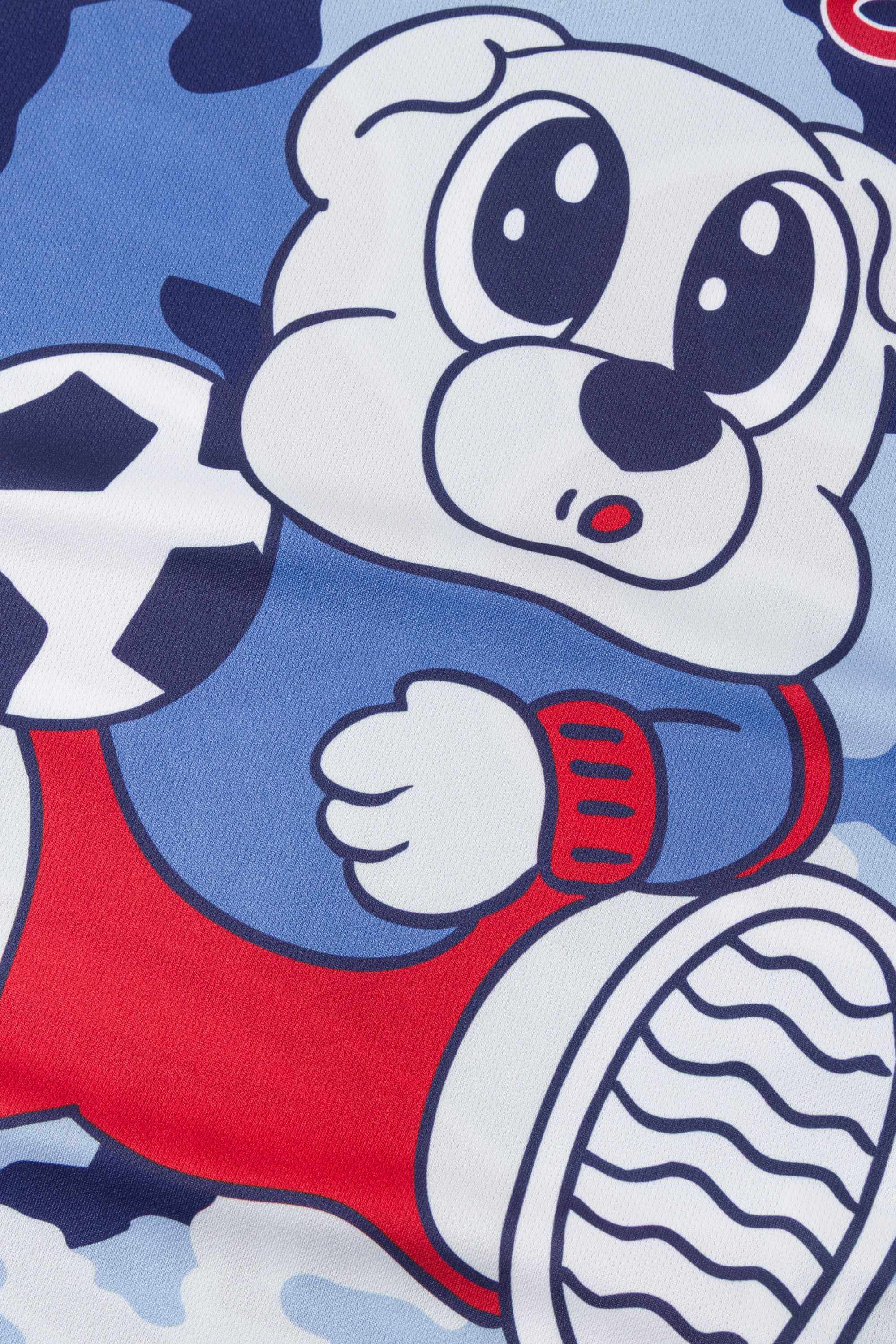 Close-up of a cartoon character in a red and blue outfit with a soccer ball graphic on a blue camouflage jersey