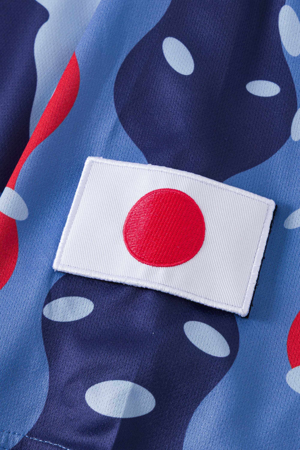 Close-up of a patch with Japan's flag on a 3 toned blue fabric with red details