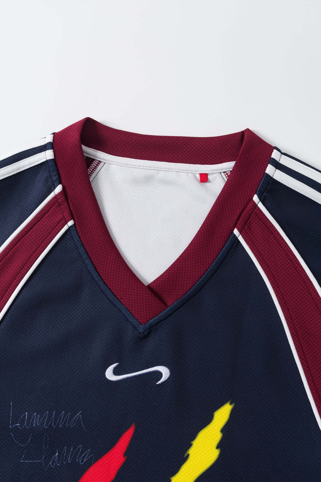 Navy sports jersey with red and white accents on a white background