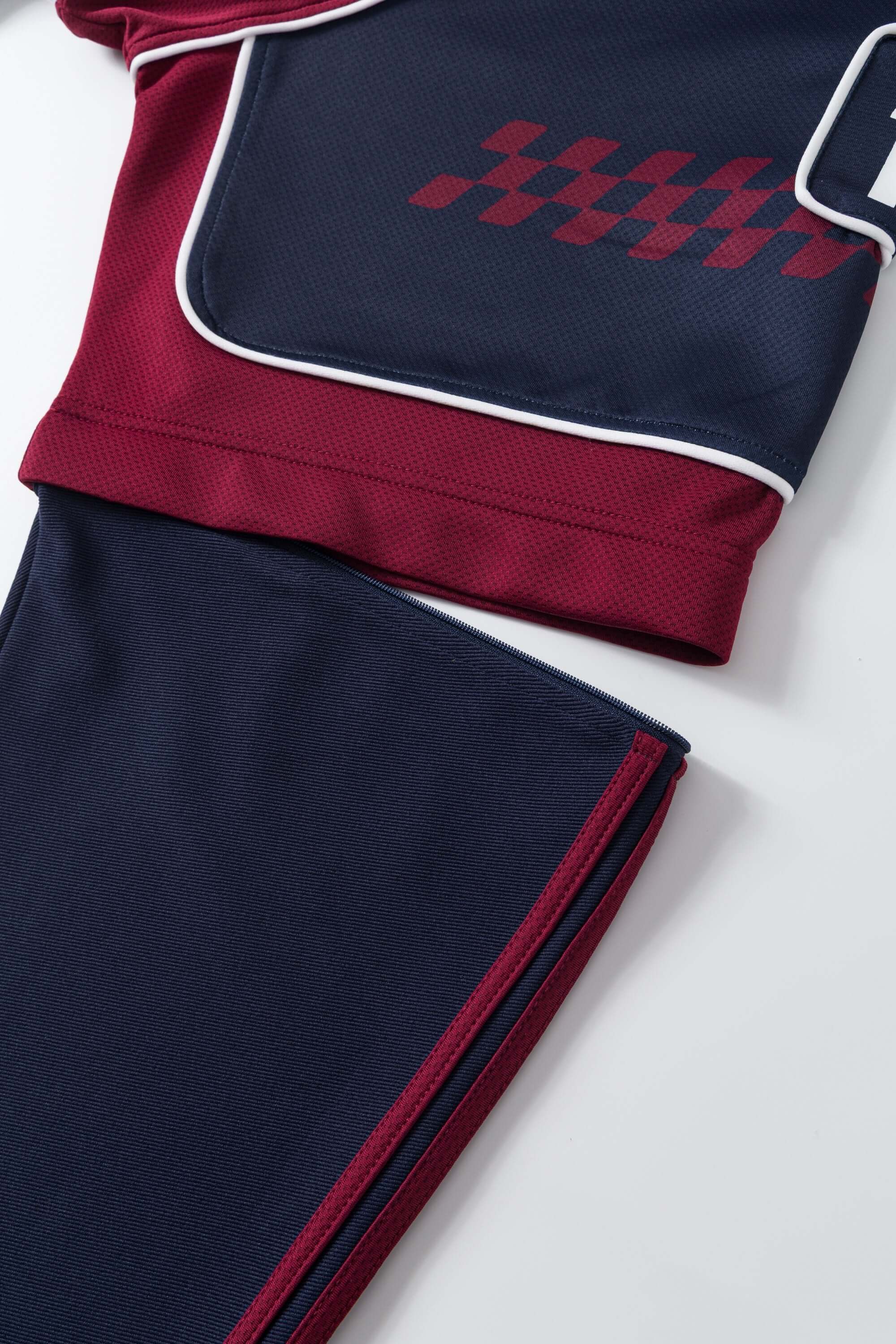 Navy and red sports jersey with detachable sleeves on a white background