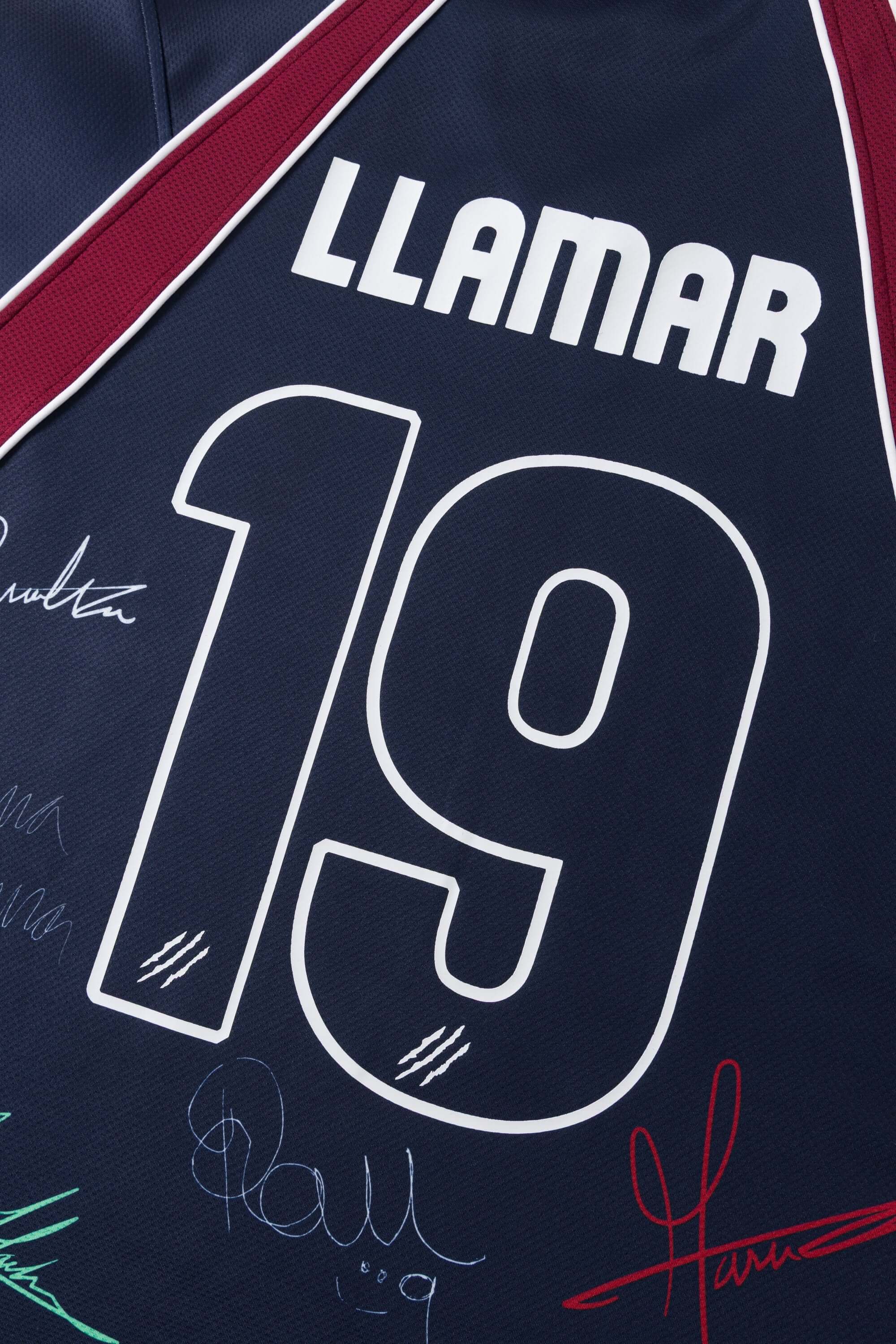 Navy sports jersey with number 19 and 'LLAMAR' branding, featuring signatures below.